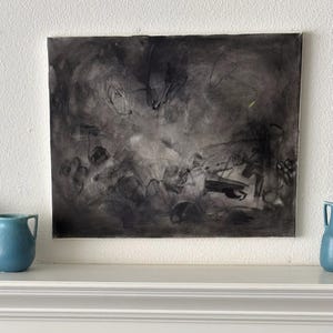 May include: A rectangular canvas painting featuring abstract charcoal and black ink marks on a light background. The composition displays layered, gestural strokes, smudges, and thin lines that create a sense of depth and movement across the surface.
