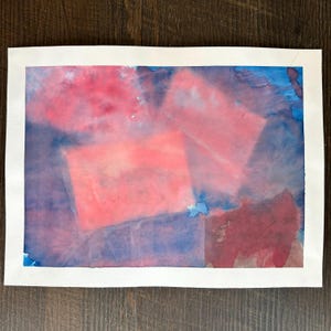 May include: Abstract watercolor painting with shades of pink, blue, and purple. The painting features overlapping shapes and a textured, layered effect.