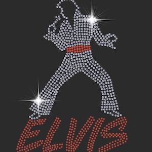 May include: A rhinestone design of Elvis Presley in a white jumpsuit with a red belt, singing into a microphone. The word "ELVIS" is spelled out in red rhinestones below the figure.