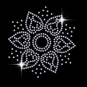 May include: A silver sparkly flower design made of rhinestones on a black background.