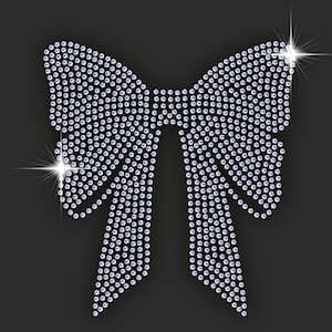 May include: A large silver bow made of rhinestones. The bow is made of many small, round rhinestones that are arranged in a pattern to create the shape of a bow.