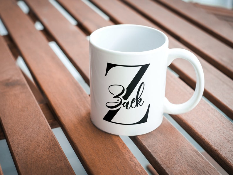 May include: White ceramic mug with a black letter Z and the name "Zack" written in a cursive font.