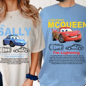 May include: Two t-shirts featuring characters from the Disney Pixar movie Cars. The first t-shirt is white with a blue car and the text "I'm Sally". The second t-shirt is blue with a red car and the text "Lightning McQueen".