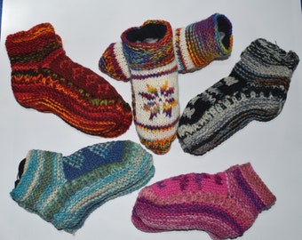 May include: Six pairs of colorful knitted wool socks. The socks are in various colors, including red, blue, green, pink, white, and black. The socks are all made of a soft, warm wool.