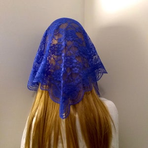 May include: A royal blue lace head covering with a scalloped edge.