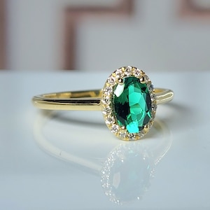 Elegant 5x7mm emerald halo ring in solid 14K gold with natural diamonds – perfect for engagement or gift. Customizable and handcrafted.