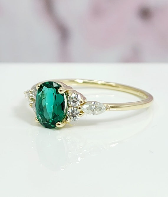 Oval Emerald and Diamond Halo Engagement Ring