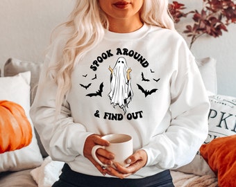 May include: White sweatshirt with a black and white graphic of a ghost with the text "Spook Around & Find Out" and bats around the ghost.