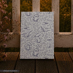May include: A canvas print featuring a repeating pattern of stylized mushrooms and foliage in shades of blue and white. The artwork is displayed on a wooden surface with a weathered white fence in the background. The words "Lifestyle Illustration" are at the bottom.