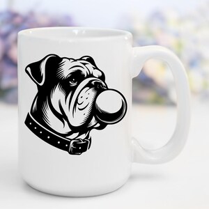 May include: White ceramic mug with a black and white illustration of a bulldog with a large bubble in its mouth.