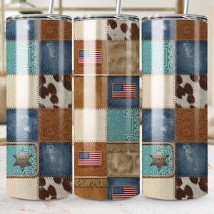 May include: A set of three stainless steel tumblers with a patchwork design. The design incorporates denim, cowhide, leather, and turquoise bandana patterns. Each tumbler features an American flag and a sheriff's badge.