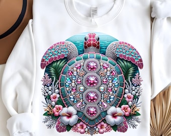 May include: White sweatshirt featuring a detailed, jewel-encrusted sea turtle design. The turtle has a teal shell, pink accents, and is surrounded by tropical flowers and foliage. The design is centered on the front of the sweatshirt.