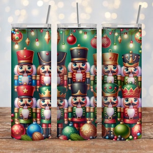 May include: Three stainless steel tumblers with a Christmas nutcracker design. The tumblers feature a green background with red, gold, and blue nutcrackers, along with Christmas lights and ornaments.