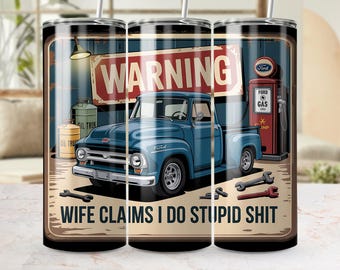 May include: A tumbler featuring a blue Ford pickup truck illustration with a red "WARNING" sign. The tumbler also has the text "WIFE CLAIMS I DO STUPID SHIT". The design includes a gas pump and tools.