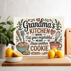 May include: A white sign with a brown wooden frame featuring a whimsical illustration of a kitchen with the text "Grandma's Kitchen - Where "Eat your vegetables" means Have another cookie."