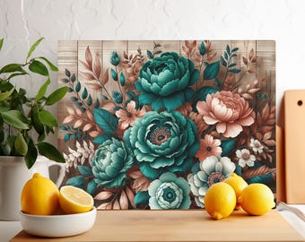 May include: A rectangular floral art print featuring teal, pink, and white flowers against a wood-grain background. The artwork is displayed on a wooden cutting board, with lemons in a white bowl and additional lemons nearby.
