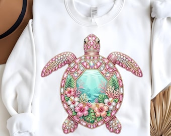 May include: White sweatshirt featuring a detailed, jewel-toned sea turtle design. The turtle has pink and gold accents, with a central image of an underwater scene with coral and flowers. The sweatshirt is a crew neck style.