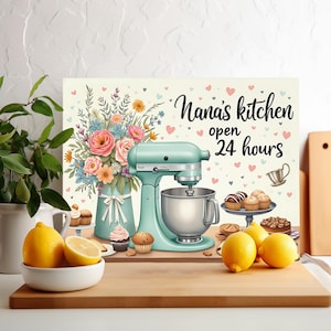 May include: A kitchen-themed sign with the text "Nana's kitchen open 24 hours". The image shows a teal stand mixer, a vase of flowers, and baked goods. Lemons in a white bowl are in the foreground, with a wooden chopping board.