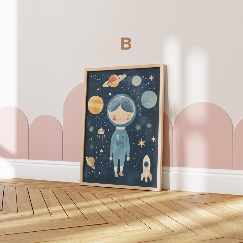 May include: A framed illustration of an astronaut in a blue spacesuit standing in front of a dark blue background with stars, planets, and a rocket. The astronaut has a light blue helmet and a light blue face with brown eyes and a small smile.