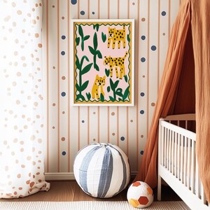 May include: A framed illustration of three leopards in a jungle setting. The leopards are depicted in a whimsical style with bright colors and bold outlines. The frame is white with a decorative border.