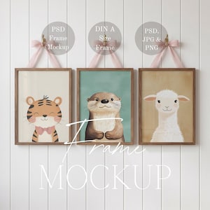 May include: Three framed art prints with animal illustrations. The prints depict a tiger with a pink bow tie, an otter, and a white llama. Each print is in a wooden frame and suspended by a pink ribbon.