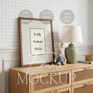 May include: A framed print with the words "Be Silly, Be Honest, Be Kind" in a brown frame. The frame is on a wooden dresser with a lamp and a stuffed bunny. The frame is 11x14 inches.