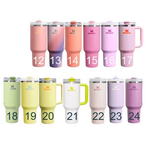 a collection of colorful stainless steel tumblers or thermos bottles, each with a unique color and size. The bottles are arranged in rows, with numbers indicating their size, and the brand name "STANLEY" is visible on each bottle.