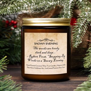 May include: A brown glass candle jar with a gold lid. The label reads "Snowy Evening" and features a quote from Robert Frost's poem "Stopping By Woods on a Snowy Evening". The candle is hand-poured coconut wax and is 9 ounces.