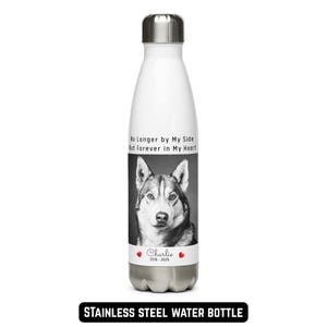 May include: White stainless steel water bottle with a black and white image of a dog. The bottle has the text "No Longer by My Side But Forever in My Heart" and "Charlie 2016-2026". The bottom of the bottle has the text "STAINLESS STEEL WATER BOTTLE".