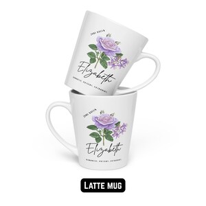 May include: Two white latte mugs stacked, each with a purple rose and floral design. The name "Elizabeth" is scripted below the flower, with the words "Romantic, Patient, Extrovert" below the name. The text "June Queen" is above the flower.