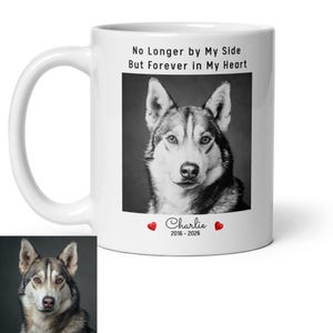 May include: White ceramic mug featuring a black and white portrait of a Husky dog. The mug has the text "No Longer by My Side But Forever in My Heart" and the name "Charlie" with dates 2016-2026.