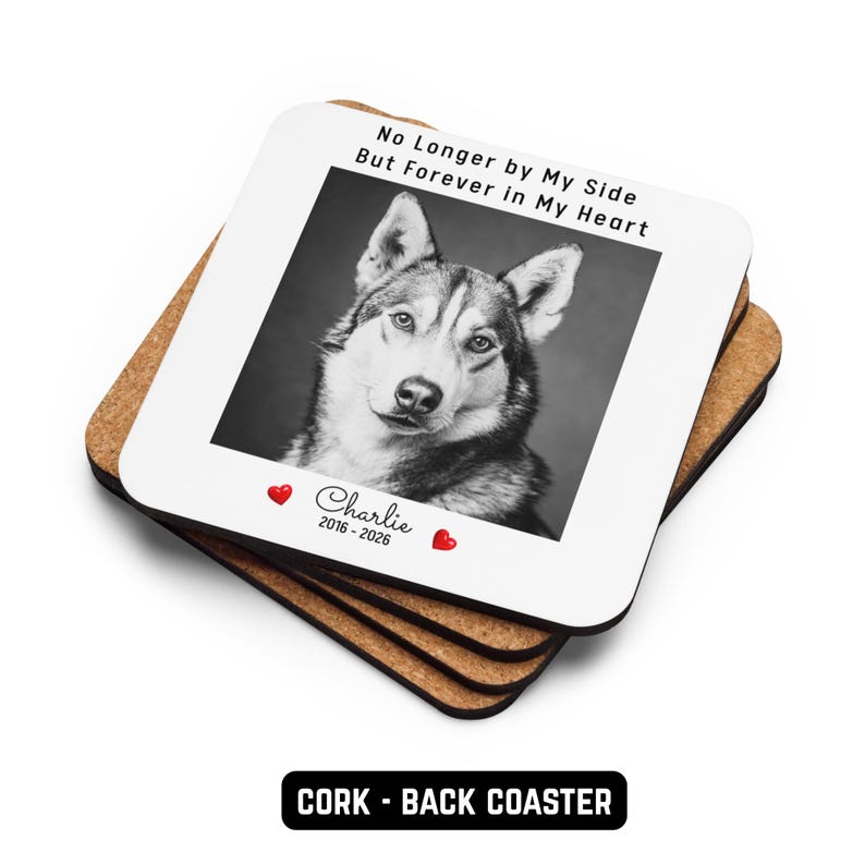 May include: A stack of square cork coasters. The top coaster has a black and white photo of a dog with the text "No Longer by My Side But Forever in My Heart". Below the photo is the name "Charlie" and the years "2016-2026".