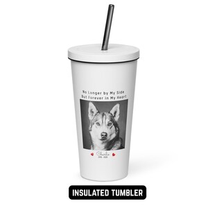 May include: White insulated tumbler with a black lid and straw. The tumbler features a black and white photo of a dog, the text "No Longer by My Side But Forever in My Heart", the name "Charlie", and the years 2016-2020.