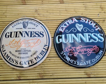 Pair of Guinness domed tin wall signs