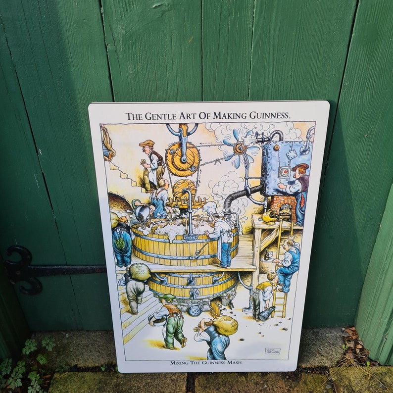 May include: A vintage-style illustration depicting the process of making Guinness beer. The image shows a cartoon-like depiction of a brewery with workers, machinery, and a large vat labeled "Mixing the Guinness Mash". The text "The Gentle Art of Making Guinness" is at the top of the image.