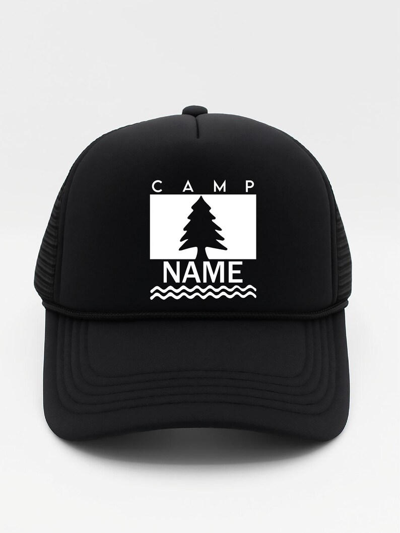May include: Black trucker hat with a white graphic. The graphic features the word "CAMP" above a tree inside a white rectangle, with the word "NAME" below, above wavy lines. The hat has a mesh back and a curved peak.