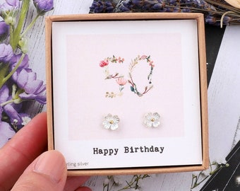 May include: A small gift box with a pink background and the number 30 made of flowers. The box contains a pair of silver flower stud earrings. The text on the box reads "Happy Birthday".