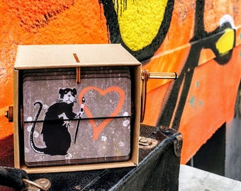 Banksy "Rat painting heart" print in a flip book picture frame: street art object