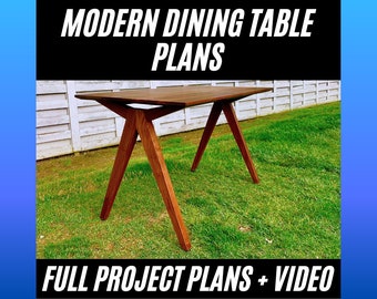 May include: A dark brown wooden dining table with a modern design. The table has a rectangular top and four angled legs. The table is sitting on a green lawn in front of a white fence. The text "MODERN DINING TABLE PLANS" is at the top of the image and the text "FULL PROJECT PLANS + VIDEO" is at the bottom of the image.