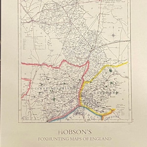 May include: A vintage map of Cambridgeshire, England, from 1870. The map is printed in black and white with red, yellow, and pink accents. The map shows the county's boundaries, rivers, and towns. The title "Hobson's Foxhunting Maps of England Cambridgeshire 1870" is printed at the bottom of the map.