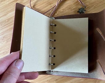 Steampunk notebook decorated with genuine old English coins. Leather binding and stamped cover. Pirate treasure notebook.