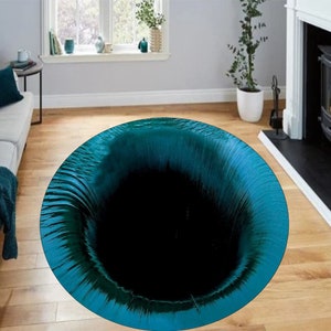 May include: A teal blue round rug with a black hole in the center. The rug is on a wooden floor.