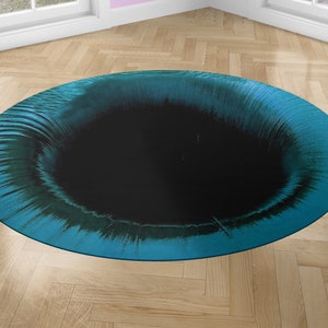 May include: A round, teal blue and black rug with a swirling pattern. The center of the rug is a black circle.