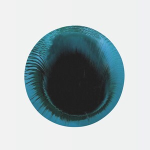 May include: A blue and black abstract circle with a swirling pattern. The center of the circle is black and the outer edge is a lighter blue.