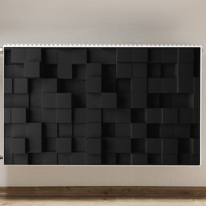 Op de afbeelding: Een zwarte radiator met een 3D-kubuspatroon. De radiator is gemonteerd op een witte muur.