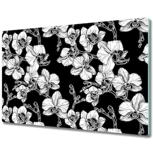 May include: Black and white line art illustration of orchids on a black background. The orchids are drawn in a detailed and realistic style, with intricate petals and stems.