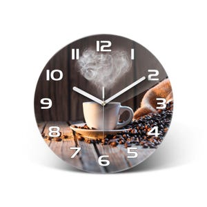 May include: A round wall clock featuring a photographic print of a white coffee cup on a saucer surrounded by scattered roasted coffee beans on a wooden surface, with steam rising in a heart shape and white numbers from 1 to 12 on the face.