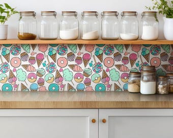 May include: A kitchen backsplash featuring a repeating pattern of colorful ice cream cones, donuts, lollipops, and cotton candy in pastel shades. A wooden shelf above holds seven clear glass jars filled with various ingredients and a small potted plant.
