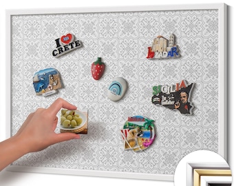 May include: A white framed magnetic board with various travel-themed magnets. The magnets include images of Crete, Zadar, Sicily, a strawberry, and a plate of olives. The background has a gray and white patterned design.