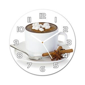 May include: White ceramic clock featuring a cup of hot chocolate with marshmallows and cinnamon sticks on a white saucer. The clock face has black numbers and hands.